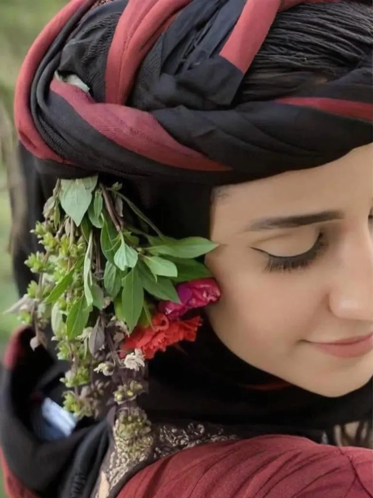 A Yemeni woman coffee farmer with fresh herbs and flowers